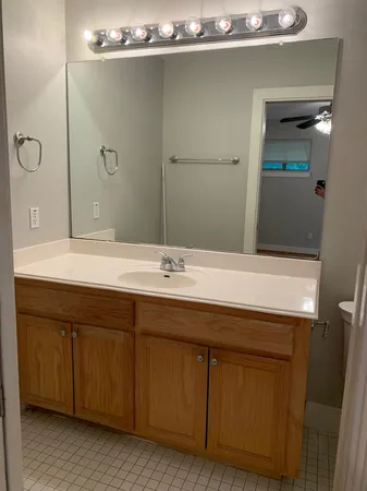 a bathroom with a double vanity sink a and mirror