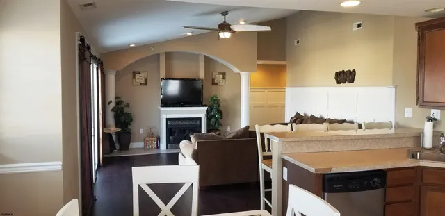 a living room with furniture a fireplace and a flat screen tv