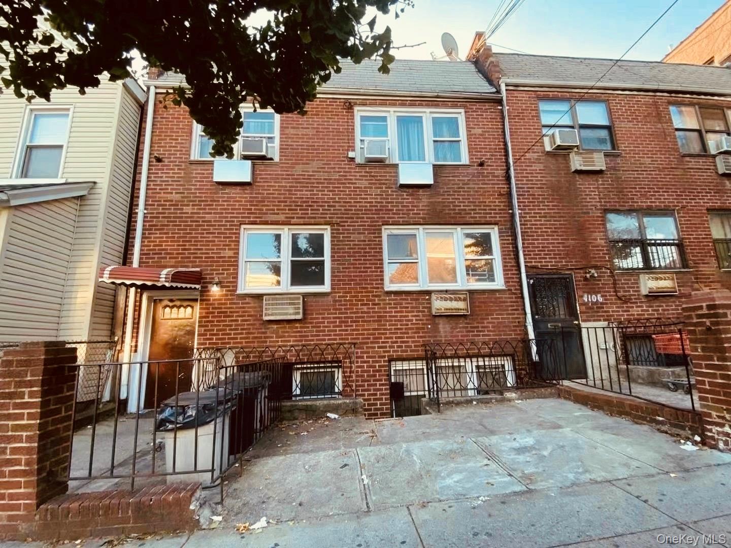 41-08 111th Street Queens, NY 11368 - Photo 2 of 9 front view of a brick house with a large windows