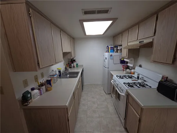 a kitchen that has a sink and a stove