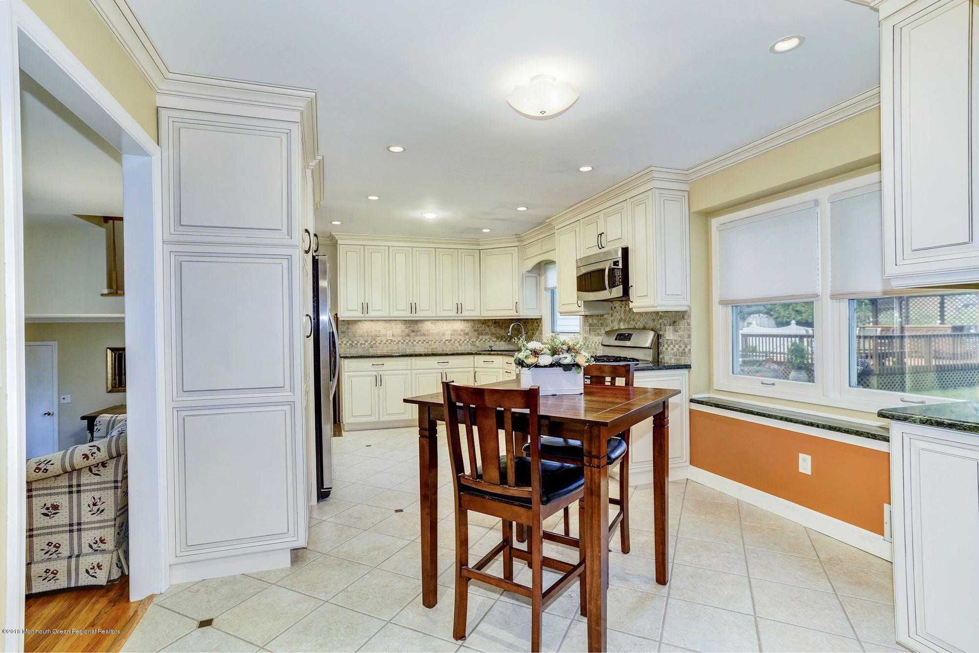3 East Point Road Lincroft, NJ 07738 - Photo 11 of 42 a kitchen with stainless steel appliances granite countertop a refrigerator and a stove top oven