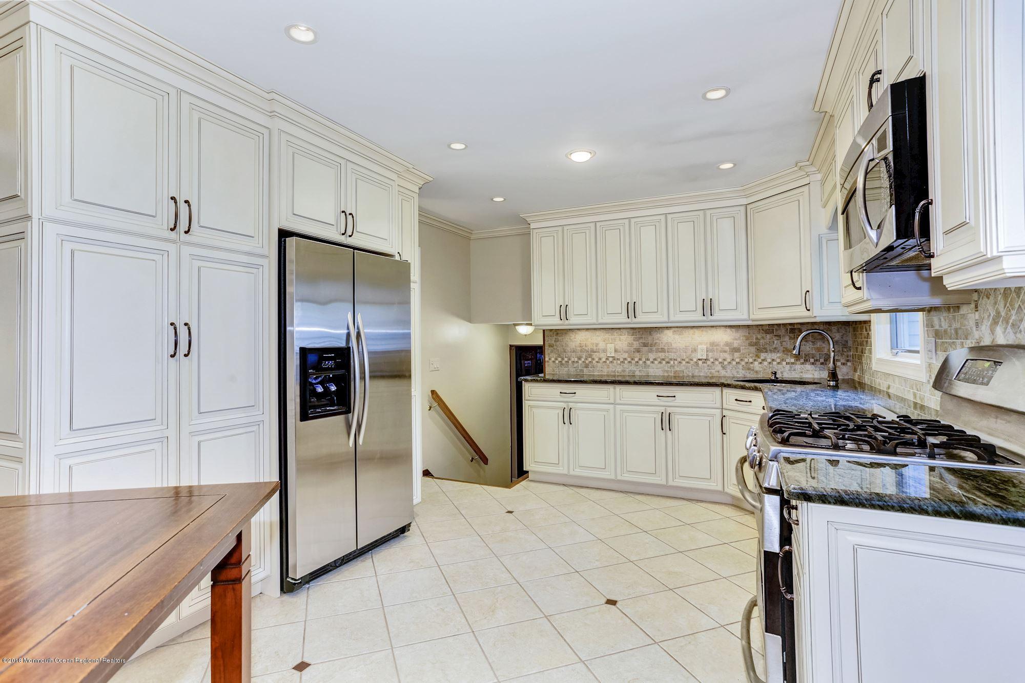3 East Point Road Lincroft, NJ 07738 - Photo 13 of 42 a kitchen with stainless steel appliances granite countertop a refrigerator and a stove top oven