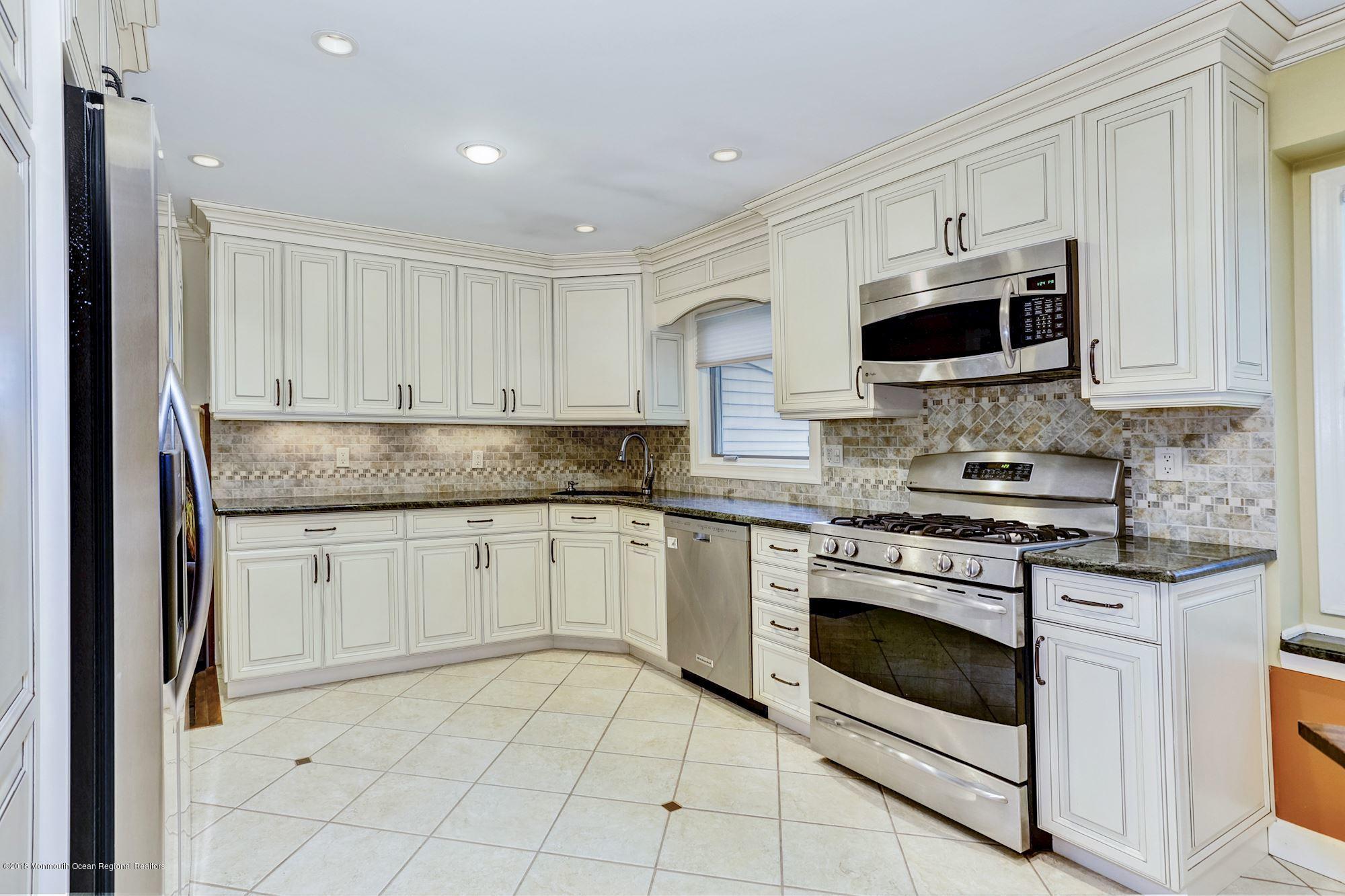 3 East Point Road Lincroft, NJ 07738 - Photo 14 of 42 a kitchen with granite countertop white cabinets and appliances