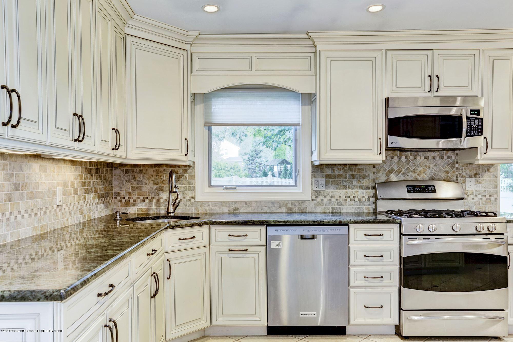 3 East Point Road Lincroft, NJ 07738 - Photo 16 of 42 a kitchen with granite countertop white cabinets and white appliances