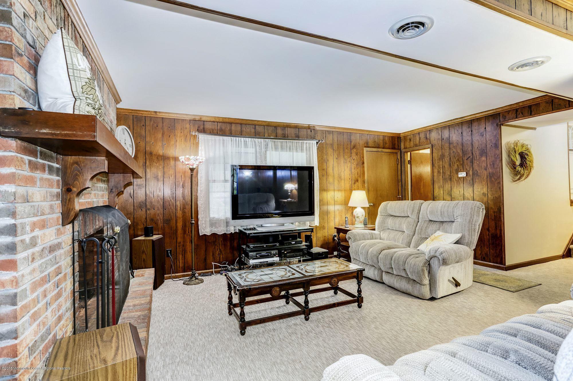 3 East Point Road Lincroft, NJ 07738 - Photo 20 of 42 a living room with furniture and a flat screen tv