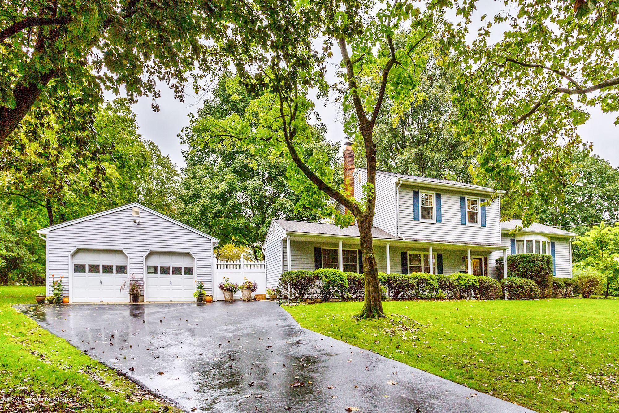 3 East Point Road Lincroft, NJ 07738 - Photo 3 of 42 a front view of a house with a garden and trees
