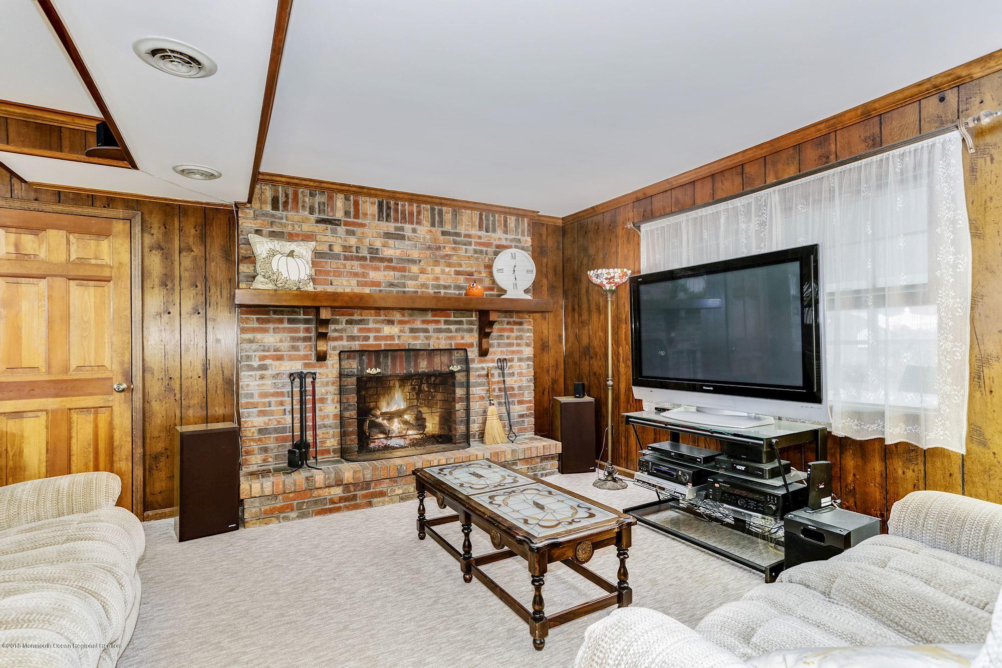 3 East Point Road Lincroft, NJ 07738 - Photo 22 of 42 a living room with furniture and a flat screen tv