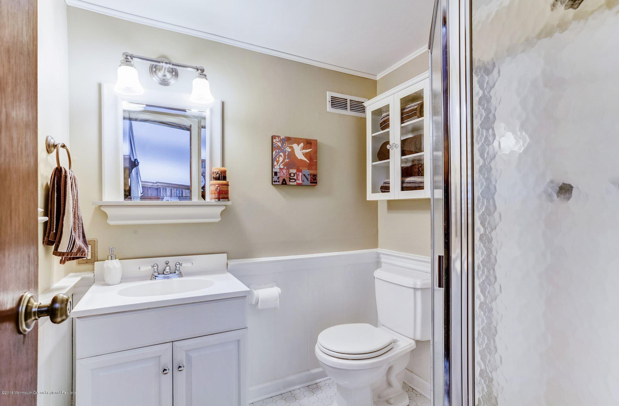 3 East Point Road Lincroft, NJ 07738 - Photo 23 of 42 a bathroom with a sink and a mirror