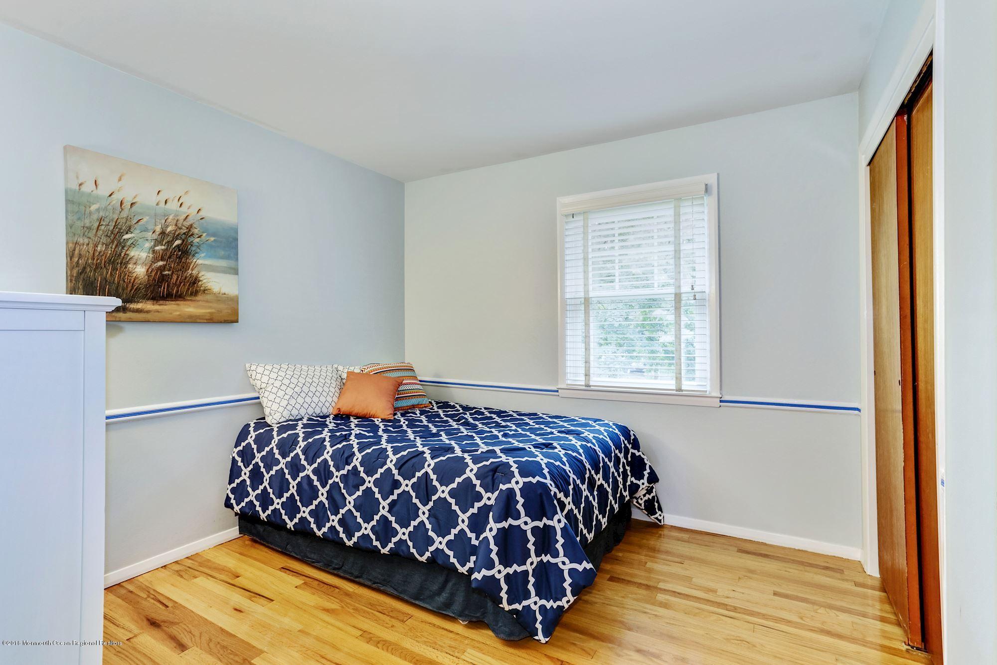 3 East Point Road Lincroft, NJ 07738 - Photo 28 of 42 a bedroom with a bed and wooden floor