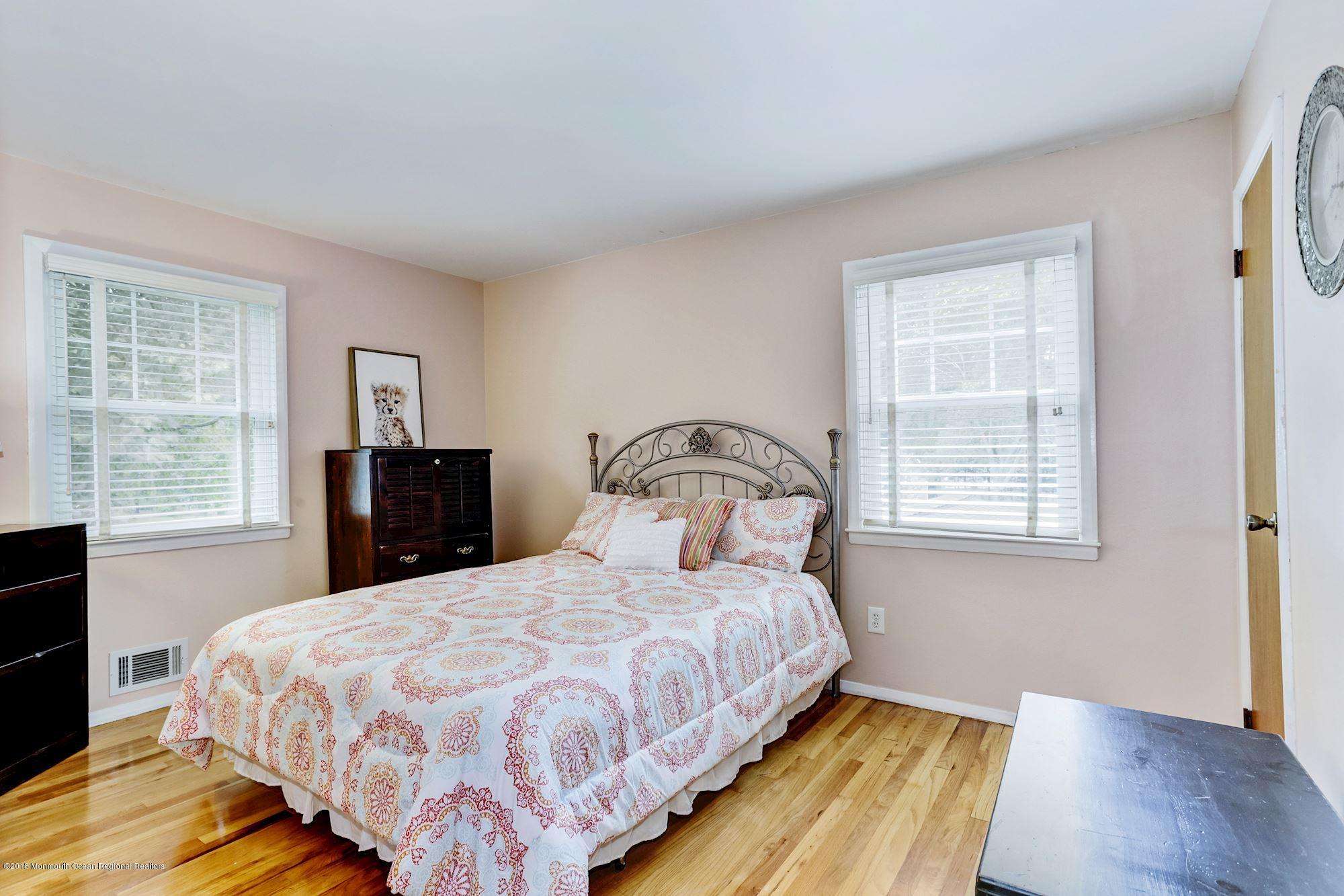 3 East Point Road Lincroft, NJ 07738 - Photo 29 of 42 a bedroom with a bed and wooden floor