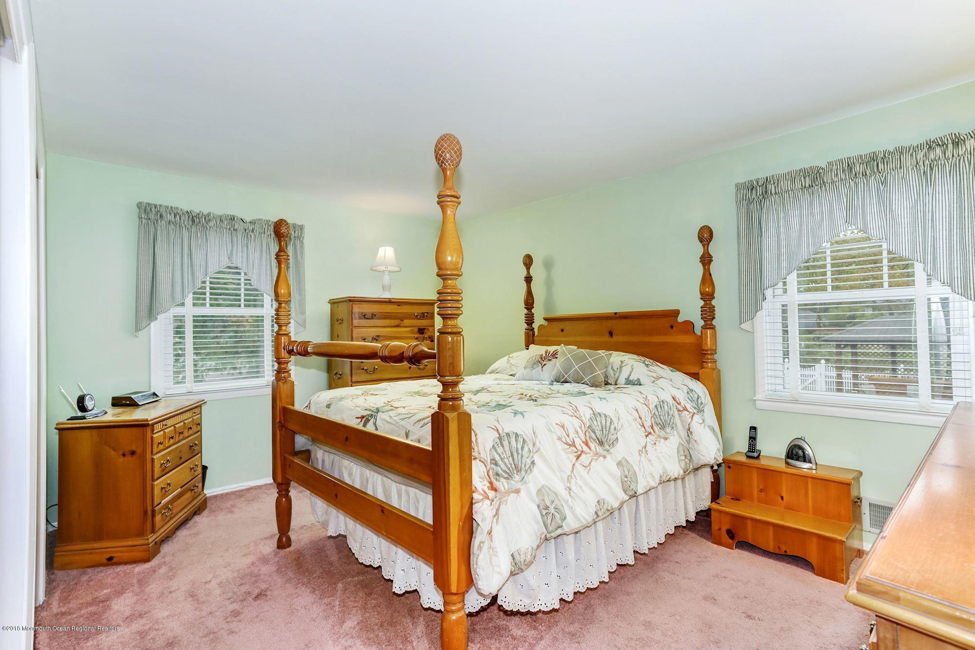 3 East Point Road Lincroft, NJ 07738 - Photo 30 of 42 a bedroom with a bed and large windows