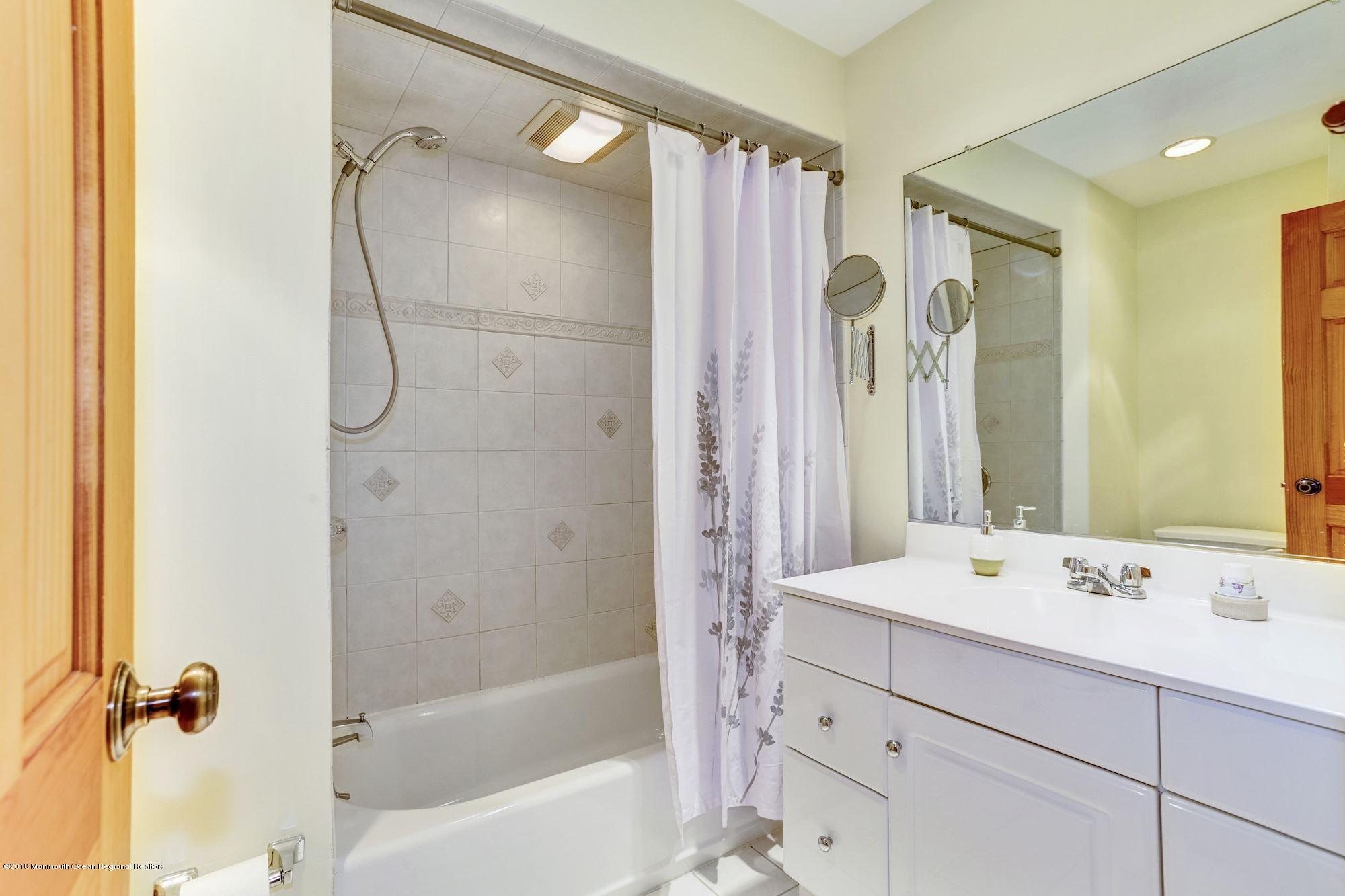 3 East Point Road Lincroft, NJ 07738 - Photo 31 of 42 a bathroom with a tub sink shower and mirror