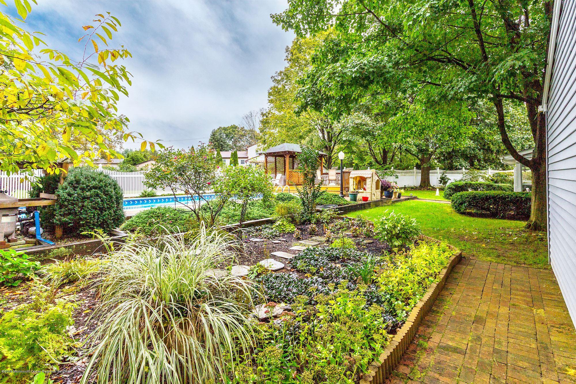 3 East Point Road Lincroft, NJ 07738 - Photo 32 of 42 a view of swimming pool with a garden