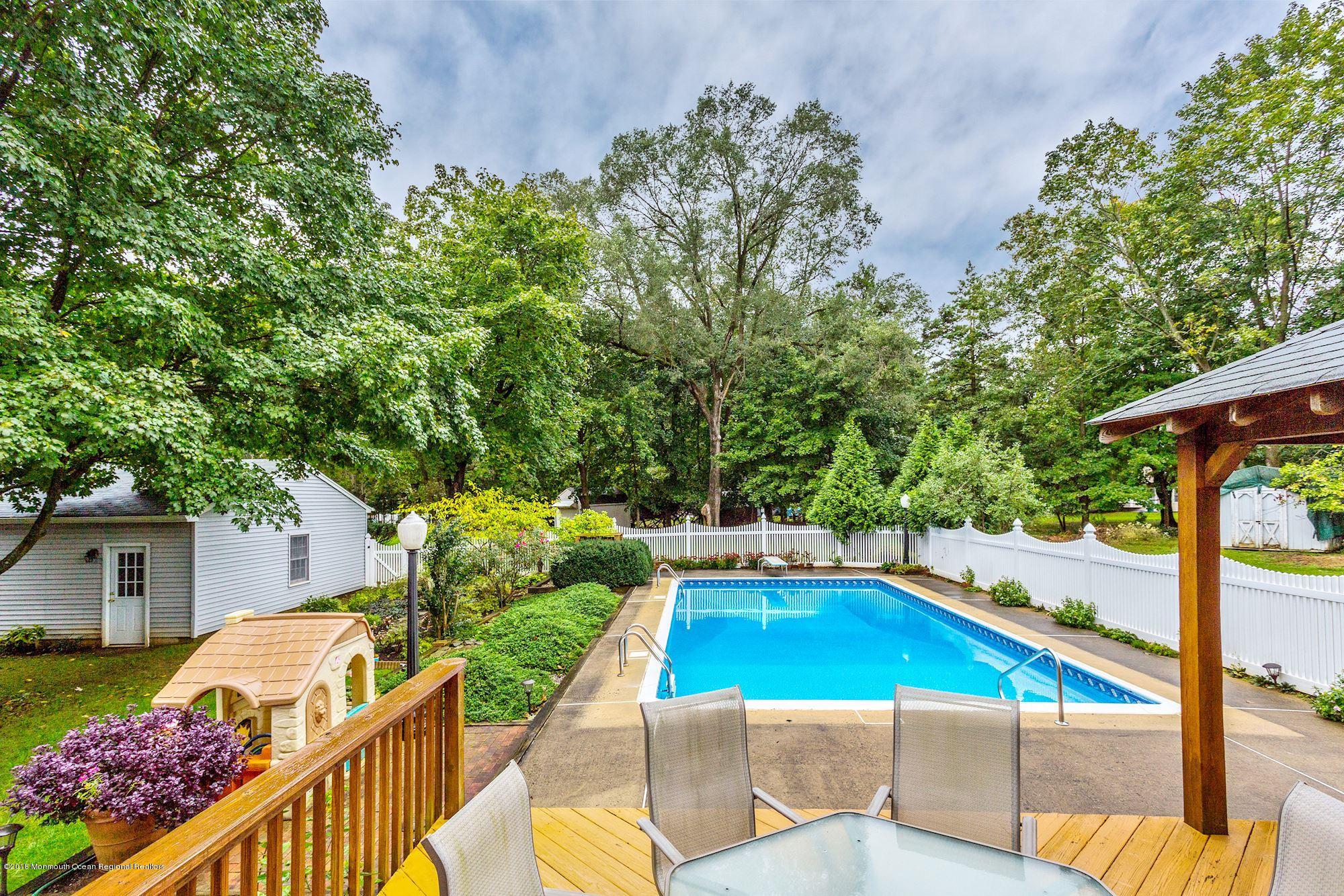 3 East Point Road Lincroft, NJ 07738 - Photo 38 of 42 a view of a swimming pool with a patio and a yard