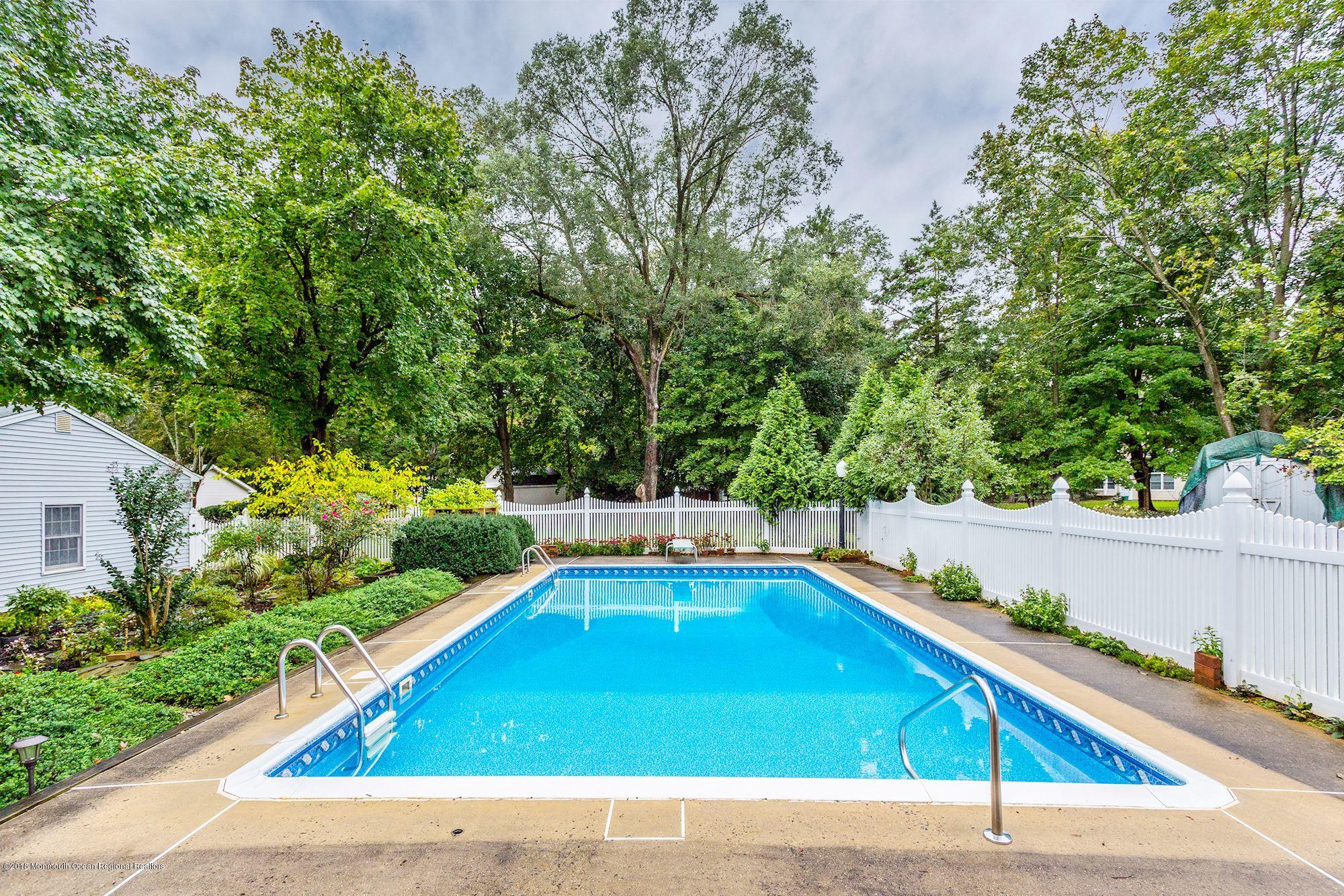 3 East Point Road Lincroft, NJ 07738 - Photo 39 of 42 a view of a pool with chairs in front of house