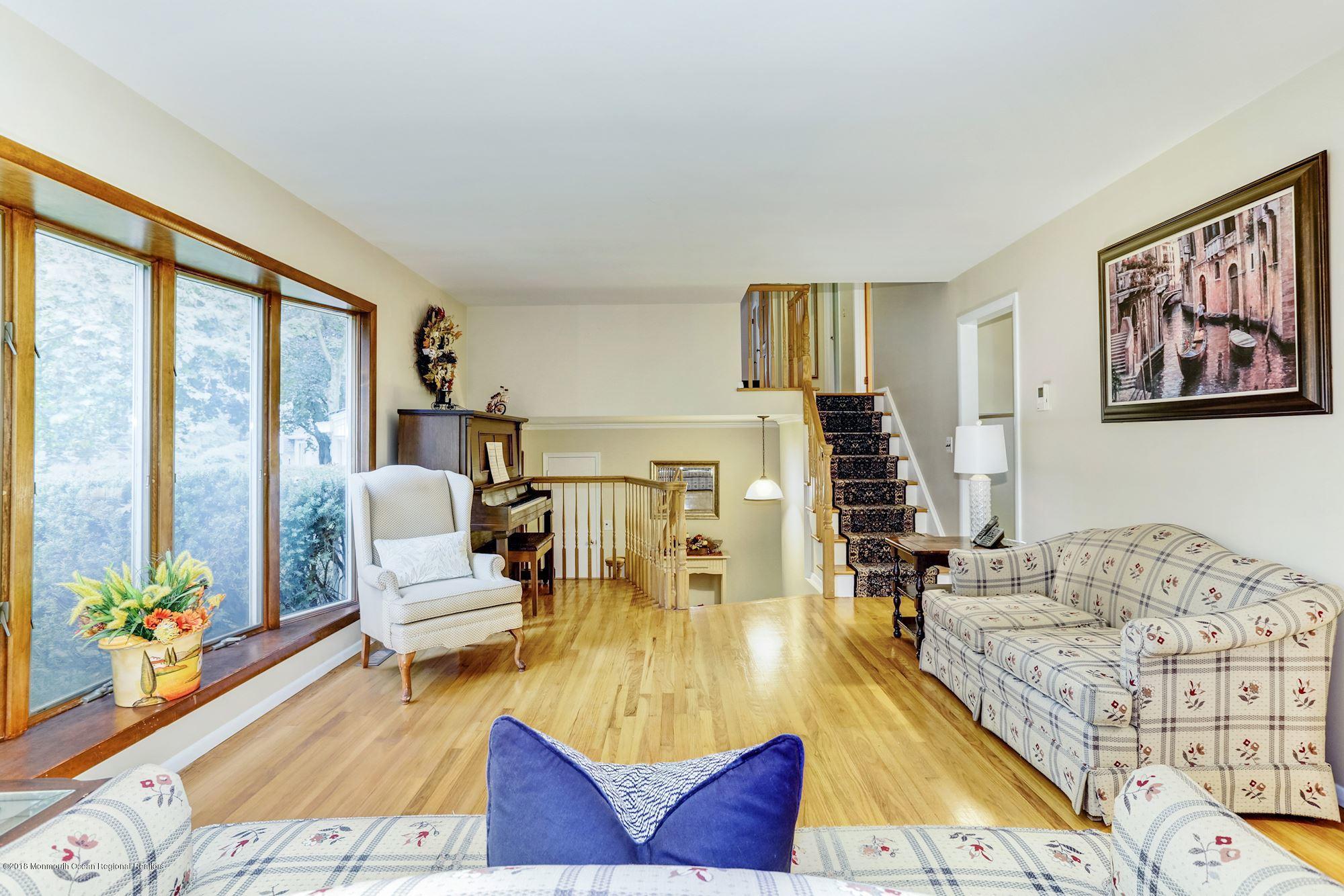 3 East Point Road Lincroft, NJ 07738 - Photo 8 of 42 a living room with furniture and floor to ceiling windows