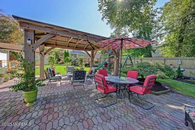 a view of a table and chairs under an umbrella in the patio