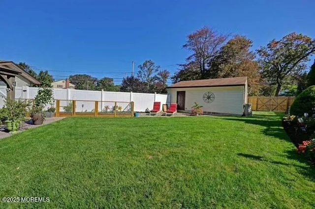 a view of an house with backyard space and garden