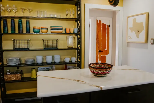 a kitchen with a sink and a stove with a dining table