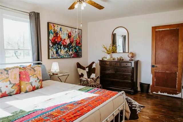 a bed room with a bed and a painting on the wall