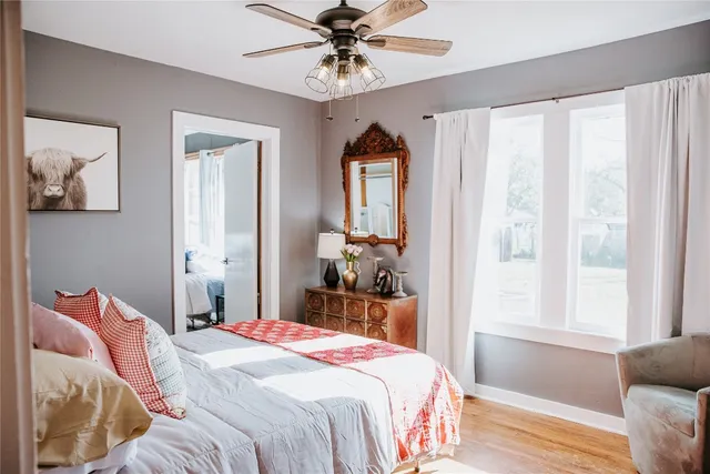 a bedroom with a bed and a chandelier