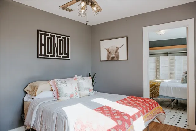 a bedroom with a bed and a chandelier