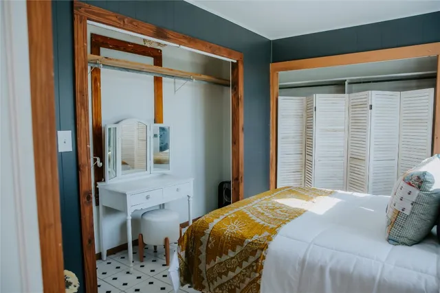 a bedroom with a bed and a mirror