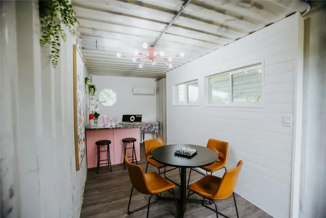 a view of a dining room with furniture and a chandelier