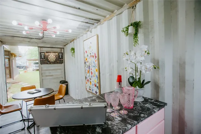 a view of a dining room with furniture and chandelier