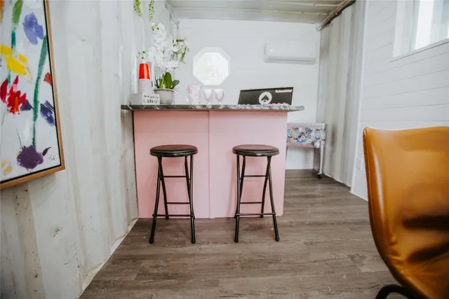 a backyard of a house with barbeque oven table and chairs