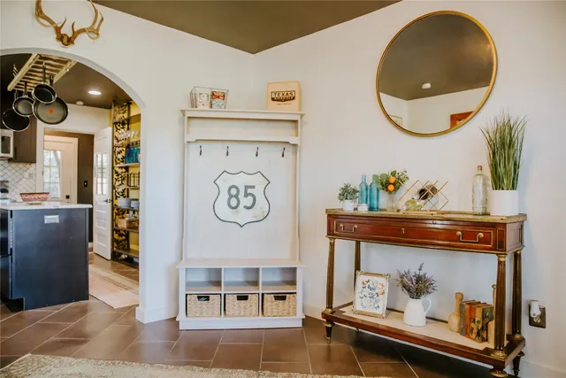 a living room with furniture and a mirror
