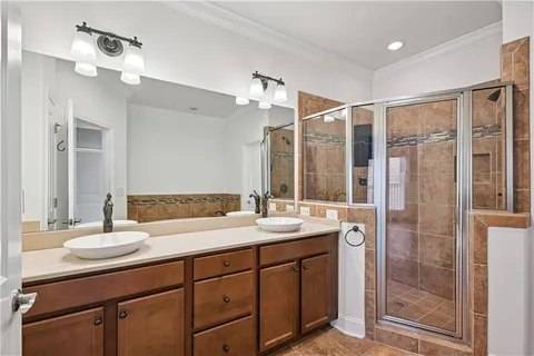 a bathroom with a shower sink vanity granite and mirror