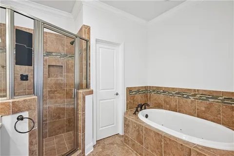 a bathroom with a tub a sink and shower