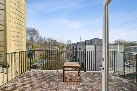 a view of a balcony with wooden fence