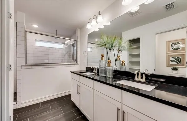 a bathroom with a double vanity sink and a mirror