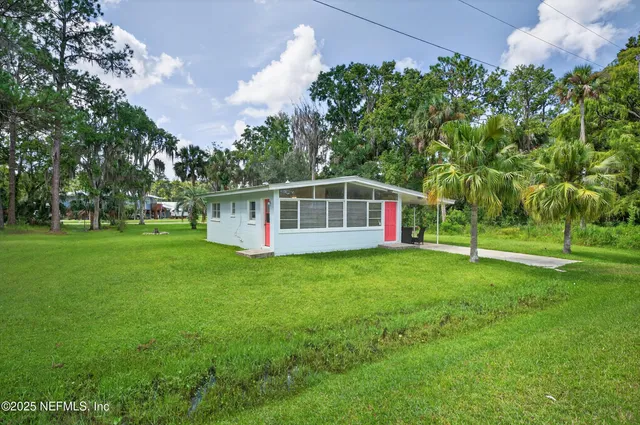 a view of a house with a yard porch and sitting area