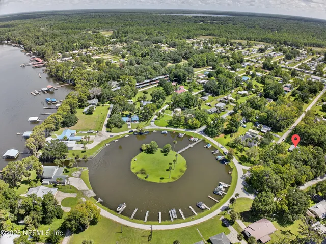 a kitchen with a refrigerator a stove top oven a sink dishwasher and a dining table with wooden floor