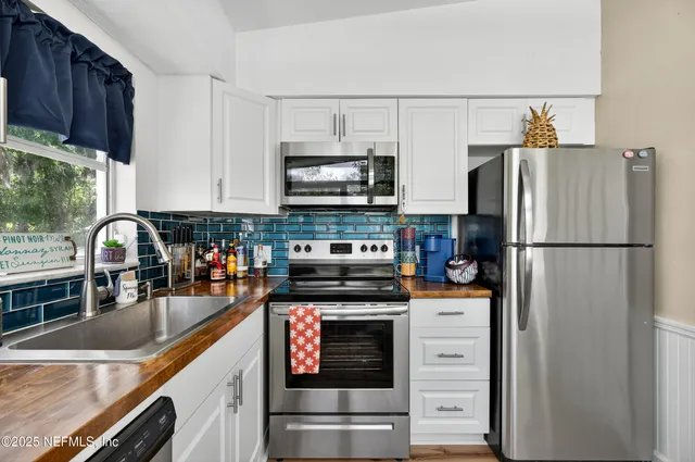 a bathroom with a sink a toilet and shower curtain