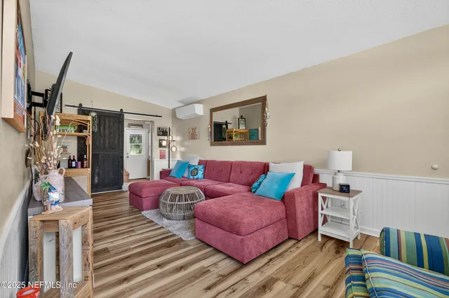 a living room with furniture and a flat screen tv