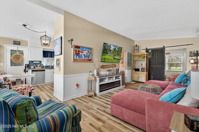 a view of a lake with a yard and potted plants
