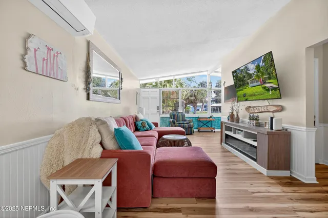 a view of grassy field with benches and trees all around