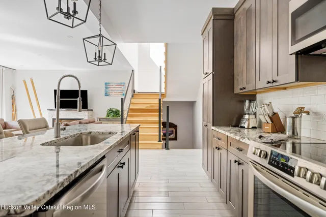 a large bed sitting in a bedroom next to a window
