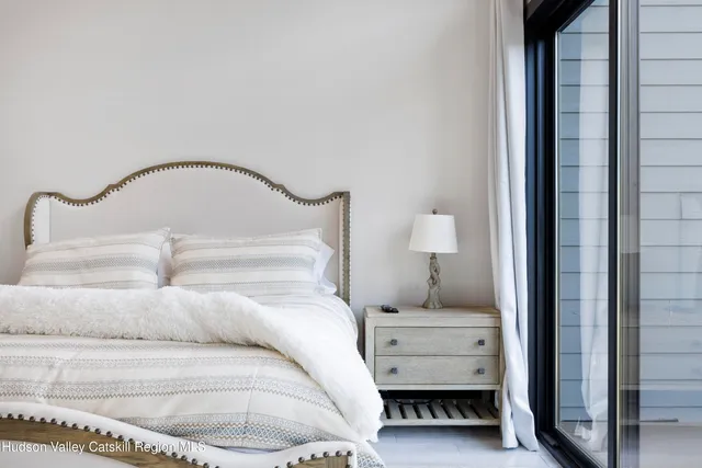 a bedroom with a bed and a mirror