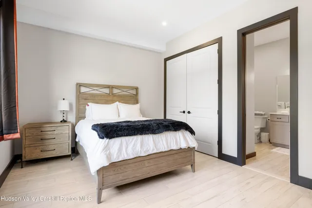 a bedroom with a bed and a mirror