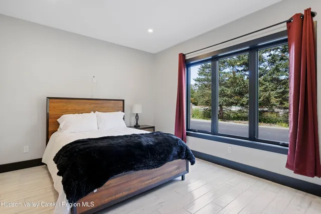 a large bathroom with a double vanity sink a large mirror and shower