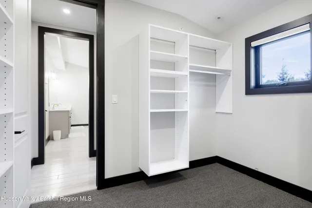 a bathroom with a sink a toilet a mirror and shower