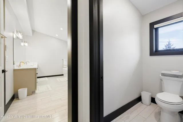 a view of a balcony with chairs and wooden floor