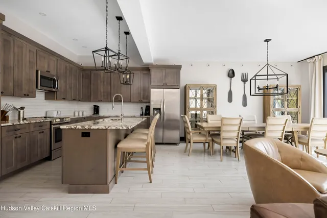 a view of kitchen with sink dining table and chairs
