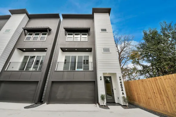 a view of a room with wooden floor lounge chair and windows