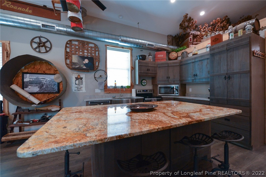 5671 Stewart Road Godwin, NC 28344 - Photo 12 of 45 a kitchen with a table and chairs in it